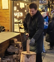 Chopping Firewood to Grill Food at a Prague Easter Market